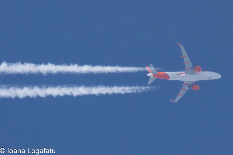 Airplane soaring through a clear blue sky